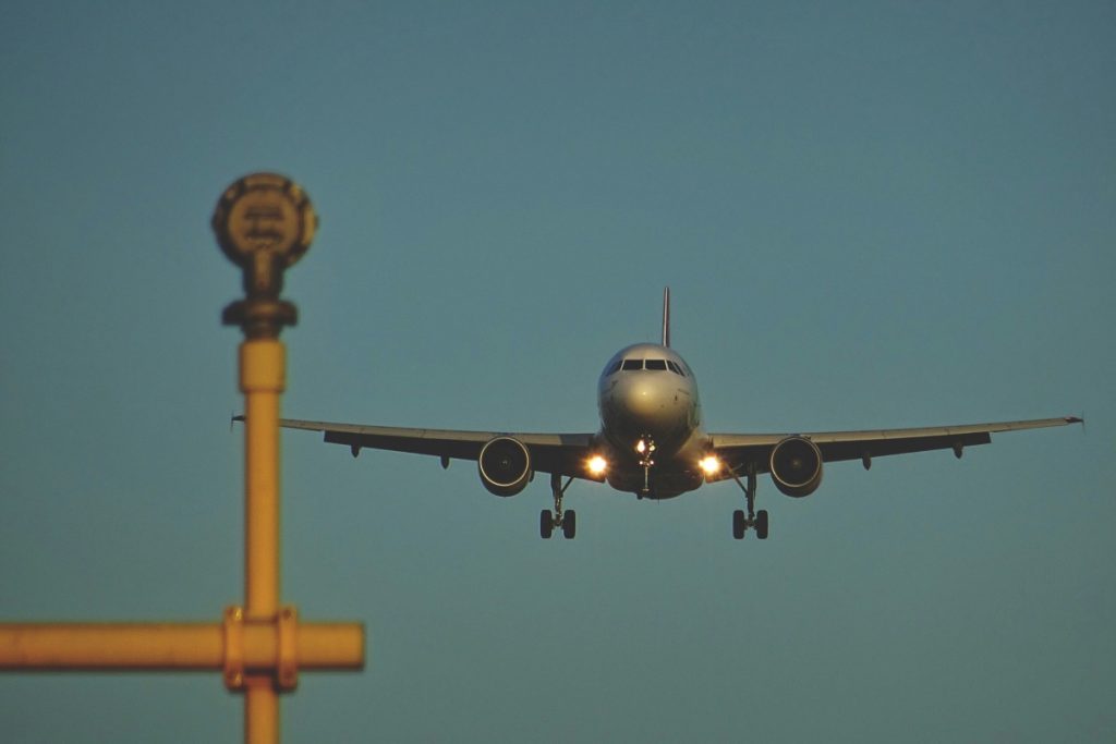 An aeroplane landing at an airport.