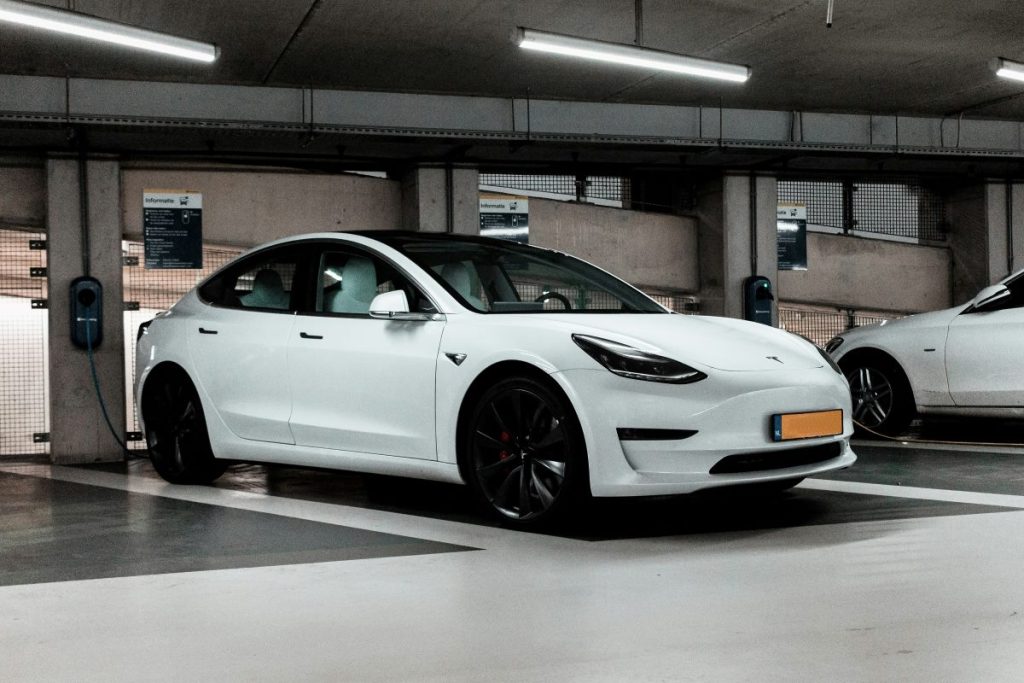 A Tesla charging at an EV charging station.